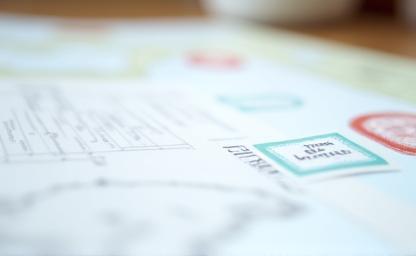 Official documents and permits required for filming displayed on a desk